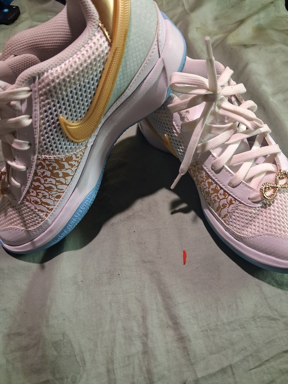Nike Women's Light Pink Sneakers with Gold Swoosh
